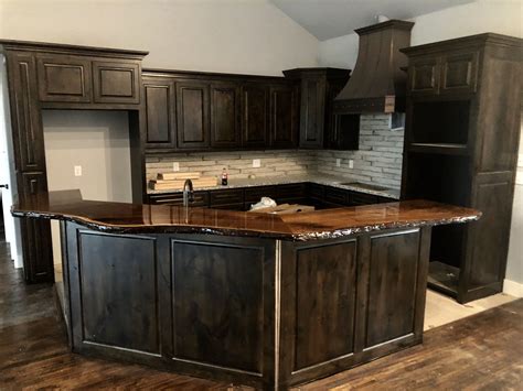 stained cabinets with black countertops